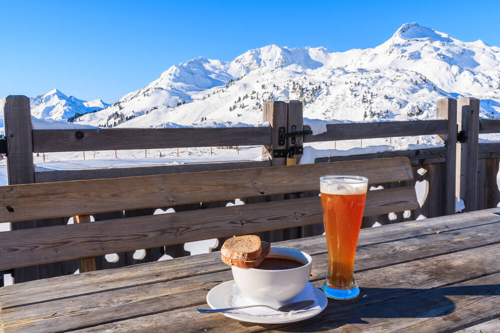 Photo of coffee and beer with a mountain backdrop at one of the snowbird restaurants