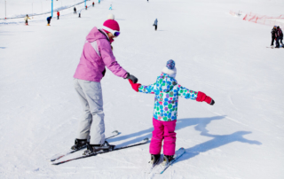 Photo of parent and child during a Snowbird ski lesson