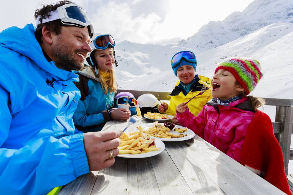 Family eating outside during the winter at Alta restaurants