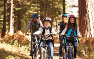 Family riding a bike enjoying outdoor activities in Utah