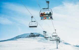 People riding on a ski lift during a ski holiday in Utah