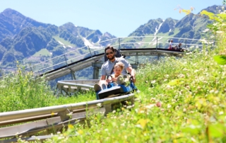 family riding mountain coaster in Snowbird Utah