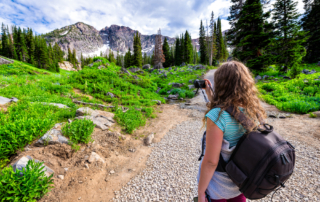 Person taking a picture while hiking in Utah's Little Cottonwood Canyon