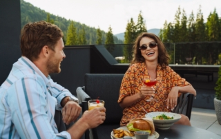 People drinking cocktails and dining at Snowbird Resort