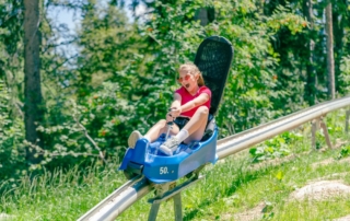 Kid riding down mountain coaster in Snowbird Utah