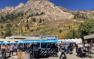 beer tents against a mountain backdrop at Oktoberfest in Snowbird Utah